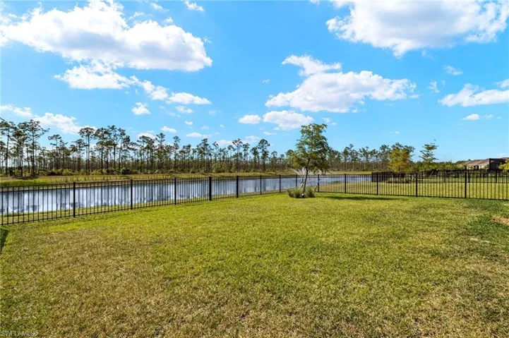 View of yard with a water view and fence