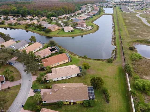 Aerial overview of property's location featuring a nearby body of water and nearby suburban area