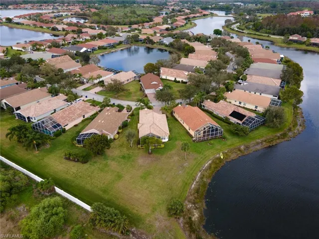 Aerial overview of property's location with a nearby body of water and nearby suburban area