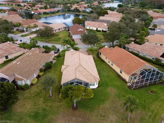 Aerial view of residential area featuring a nearby body of water