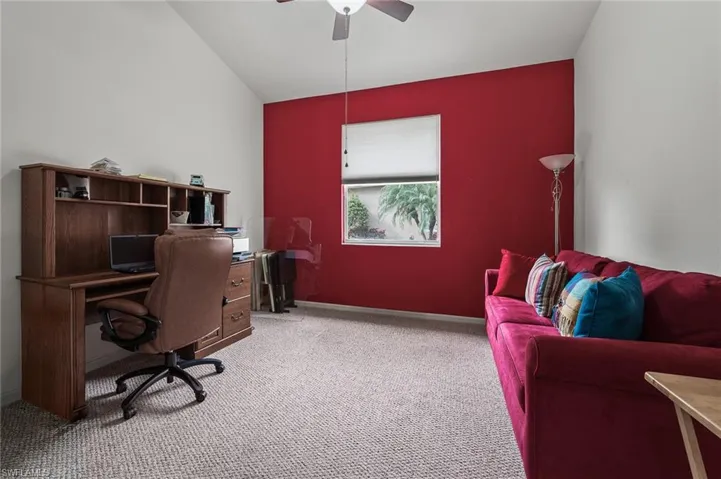 Office with carpet flooring and ceiling fan
