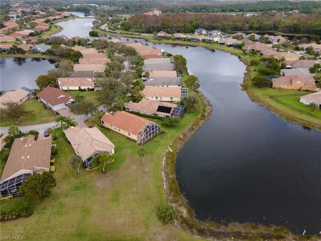 Aerial overview of property's location with a large body of water and nearby suburban area