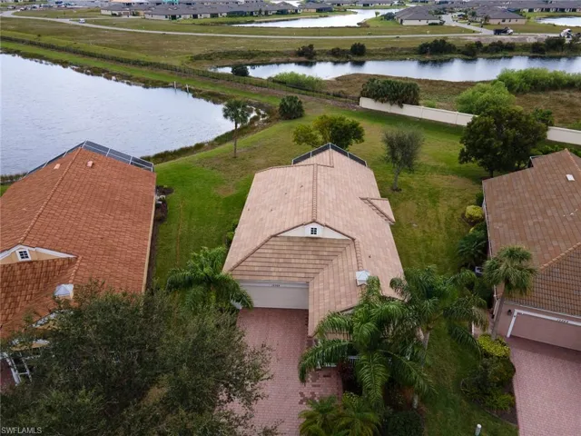 Aerial view of residential area featuring a nearby body of water