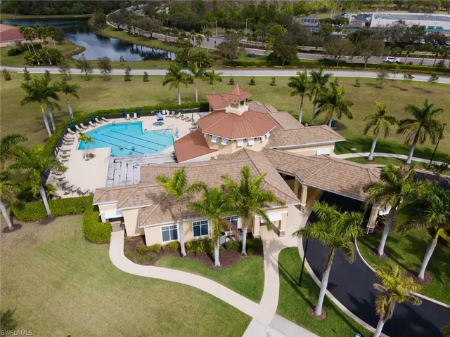 Drone / aerial view of a pool area and a large body of water