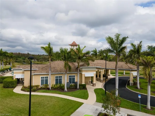 View of front facade with a front yard, stucco siding, and a patio area