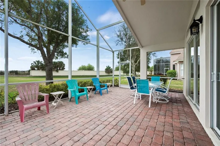 Sunroom / solarium with a patio area and a ceiling fan