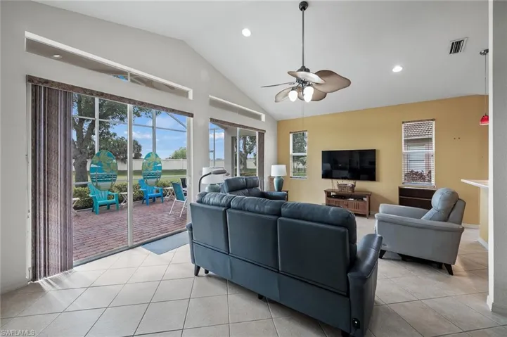 Living area with recessed lighting, a ceiling fan, plenty of natural light, light tile patterned floors, and a sunroom