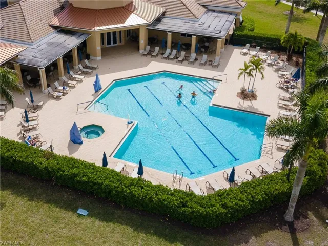 Community pool with a hot tub and a patio