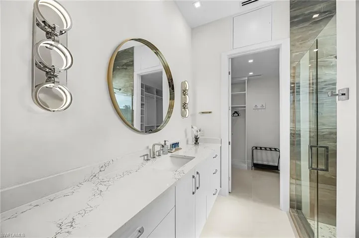 Full bath with a spacious closet, vanity, and a stall shower - Virtually Edited Image