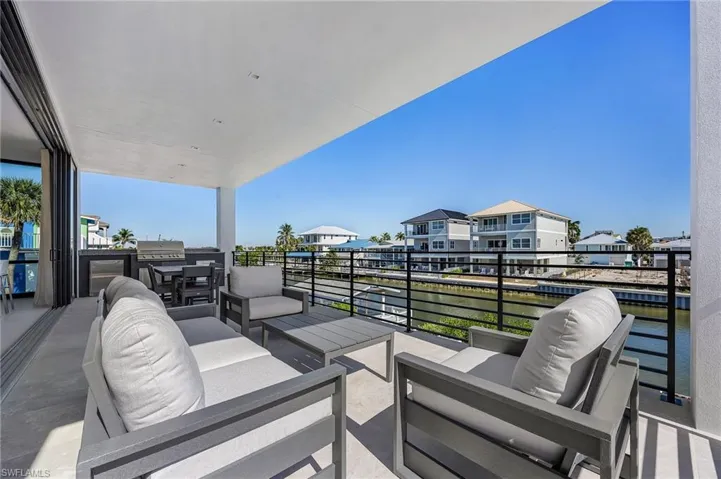 View of patio / terrace with an outdoor living space, outdoor dining space, a water view, and a grill