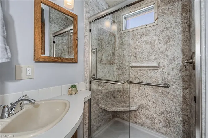Full bathroom with vanity and a stall shower