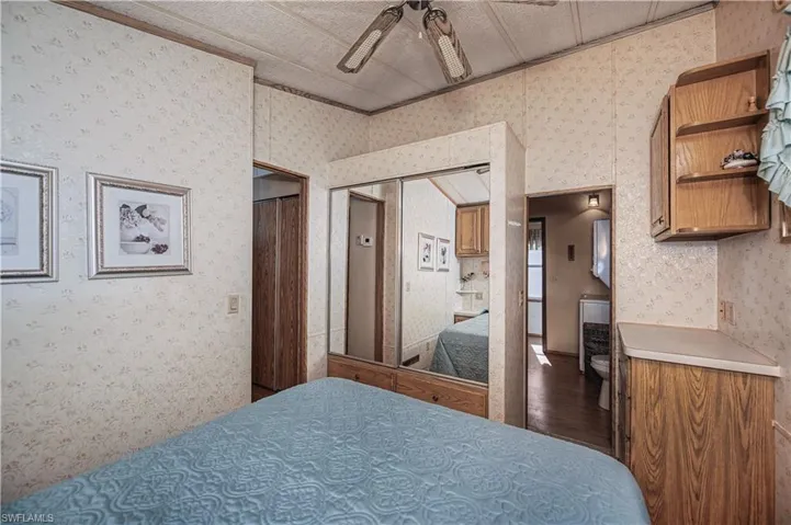 Bedroom featuring a ceiling fan and dark wood finished floors