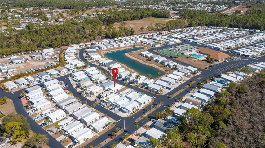 Aerial overview of property's location with a nearby body of water and nearby suburban area