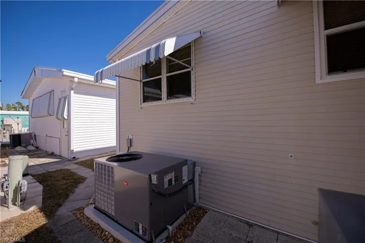 View of property exterior with a cooling unit and a patio area