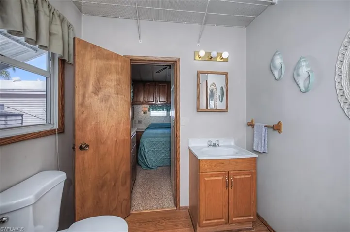 Ensuite bathroom featuring vanity and wood finished floors