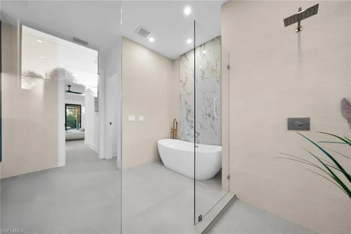 Full bathroom featuring a freestanding bath, ensuite bath, and recessed lighting