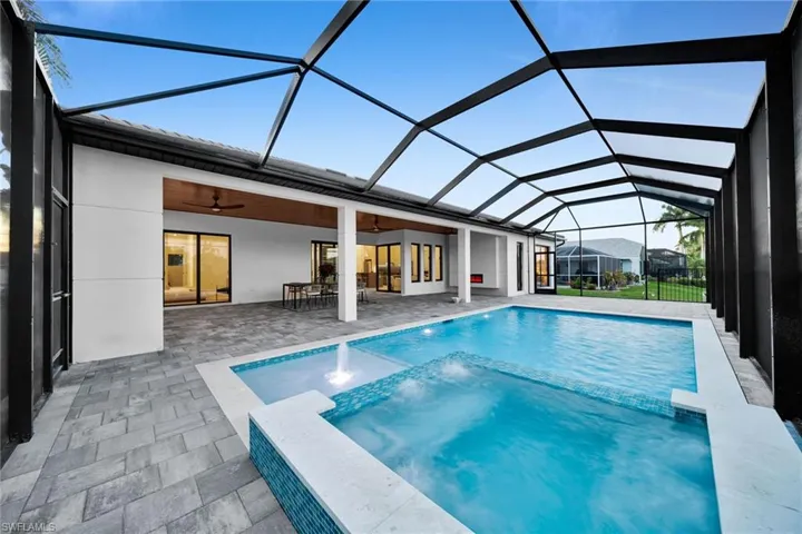 Swimming pool featuring a sunroom, a lanai, a patio area, and ceiling fan