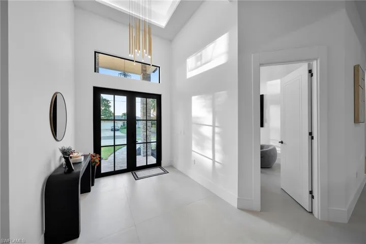 Entryway featuring a high ceiling and french doors