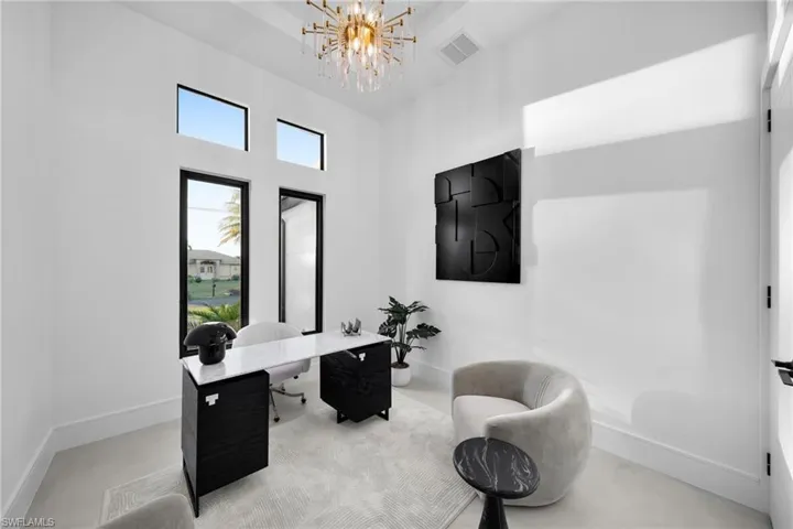 Home office with a chandelier and a high ceiling