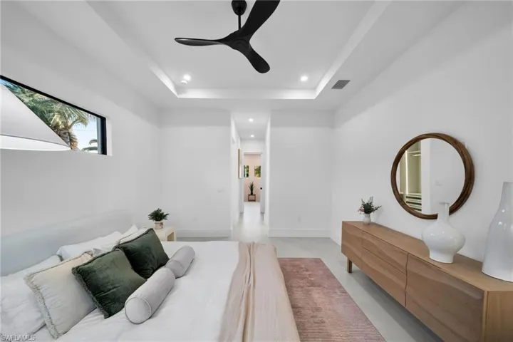 Bedroom with ceiling fan, recessed lighting, and a tray ceiling