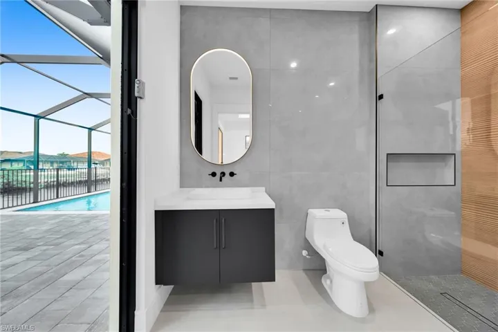 Full bath featuring tile walls, vanity, and walk in shower