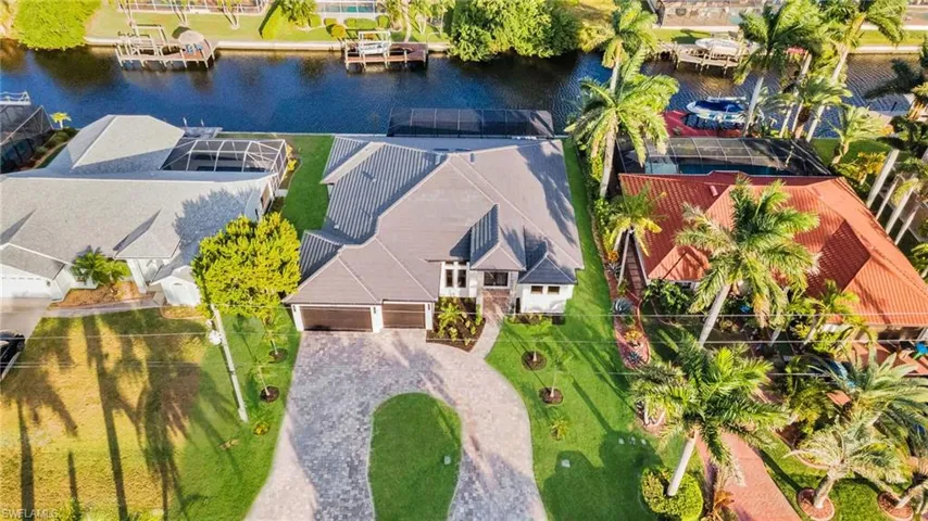 Aerial view of property and surrounding area featuring a nearby body of water