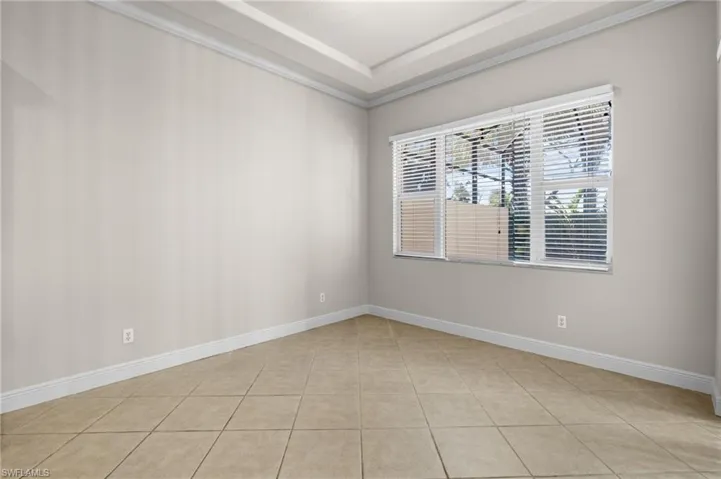 Unfurnished room featuring light tile patterned floors and crown molding