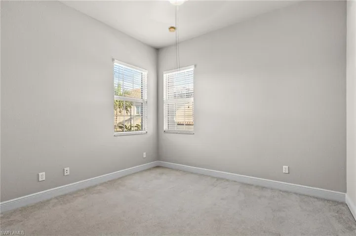 Spare room with light colored carpet