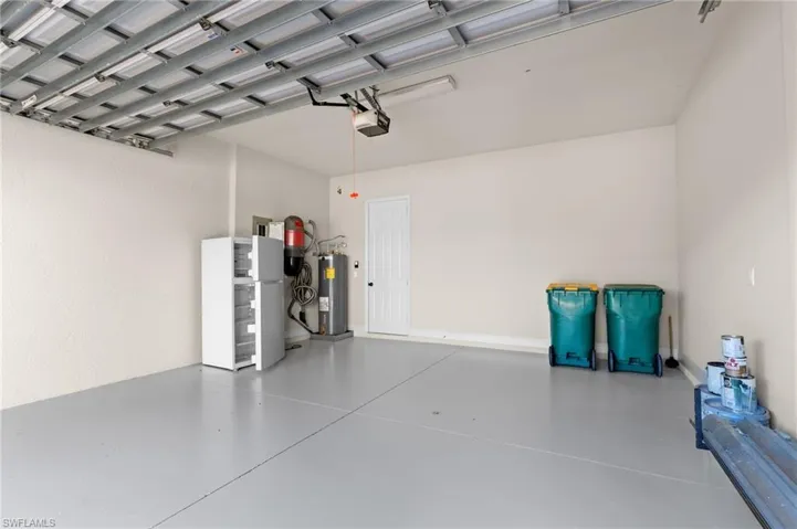 Garage with electric water heater and a garage door opener
