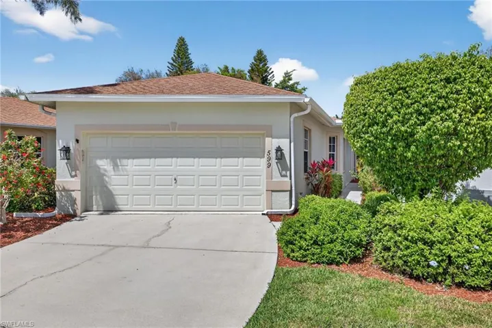 Single story home featuring an attached garage, stucco siding, and concrete driveway
