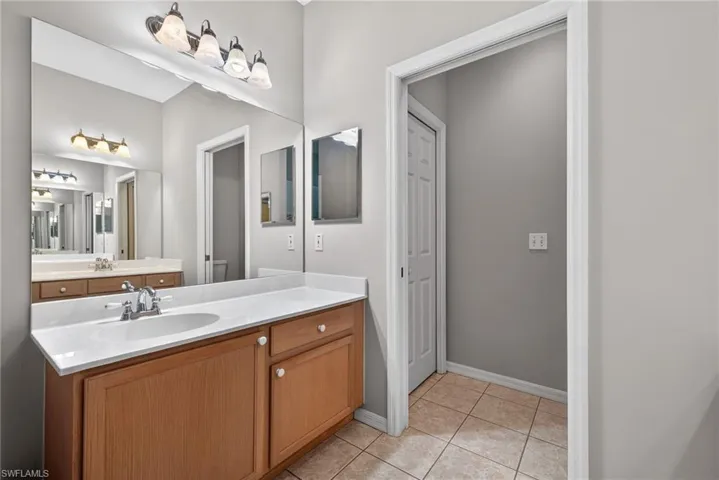 Bathroom with vanity and light tile patterned floors