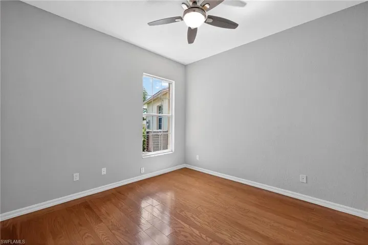 Spare room featuring wood-type flooring and a ceiling fan
