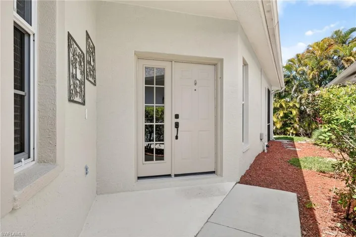 Property entrance featuring stucco siding
