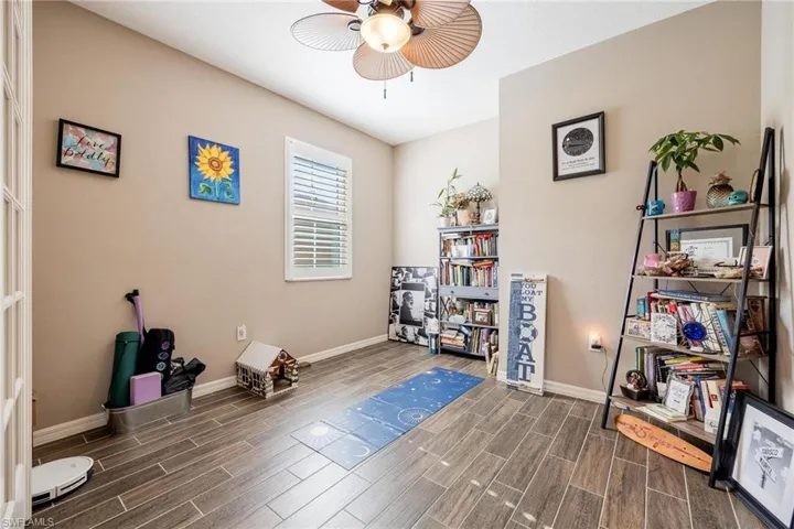 Miscellaneous room featuring dark wood-type flooring and ceiling fan