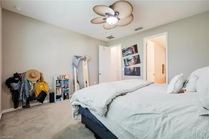 Bedroom with ceiling fan and carpet floors