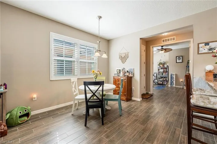 Dining room featuring ceiling fan and dark hardwood / wood-style floors