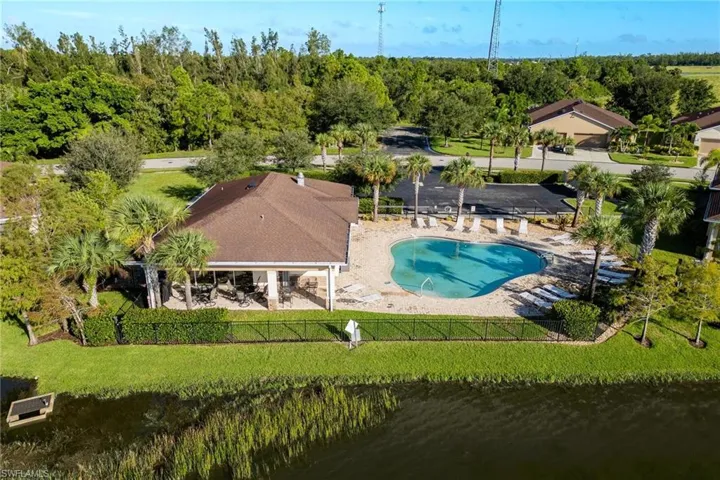 View of swimming pool with a water view, a yard, and a patio area