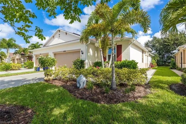 Single story home with a garage and a front yard