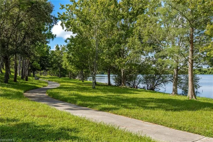 View of community featuring a water view and a yard