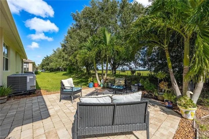 View of patio featuring an outdoor living space and cooling unit