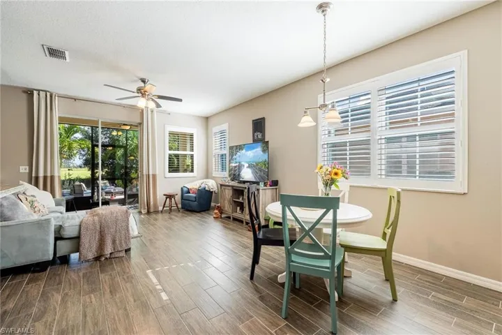 Dining room featuring a textured ceiling, wood-type flooring, and ceiling fan