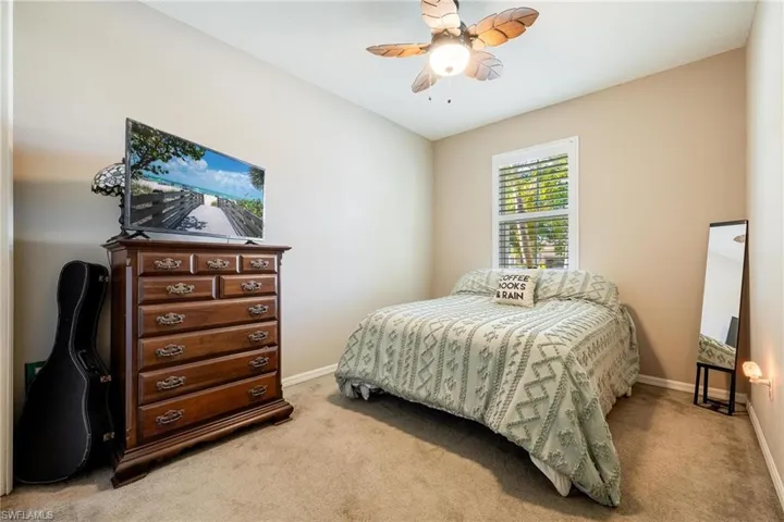 Bedroom featuring light colored carpet and ceiling fan