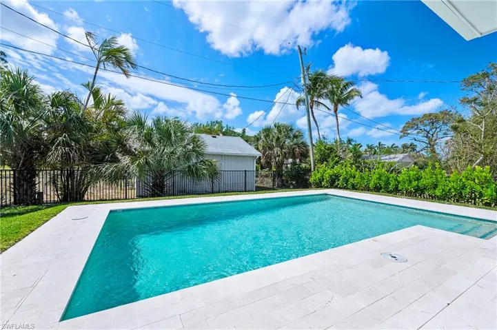 View of swimming pool featuring a fenced in pool, fence, and a patio