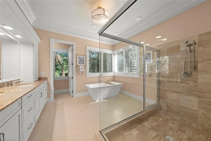 Generous primary spa-like bathroom with large shower & chic stand-alone bath