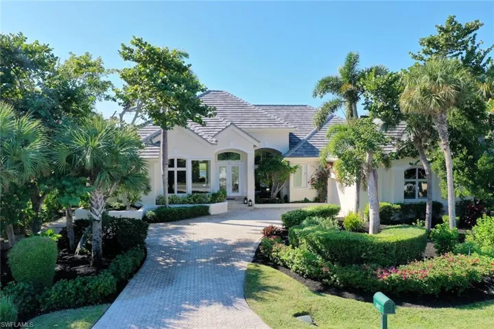 Lush landscaping frames the elegant home