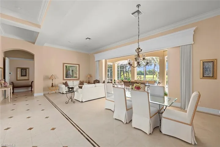 Elegant formal living & dining stuns with detailed, custom tile flooring & coffered ceiling