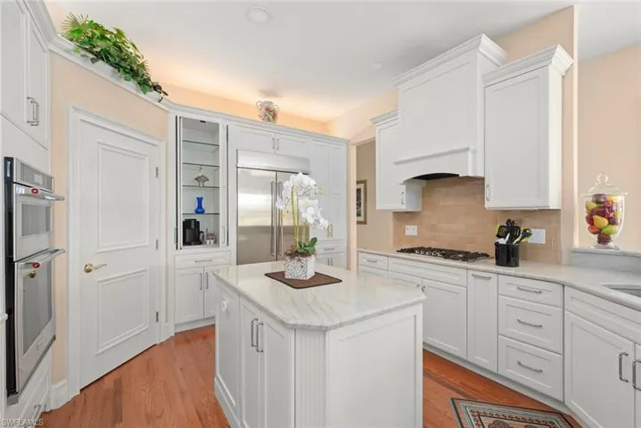 Kitchen is a chef's dream with copious cabinetry, coffee bar, large walk in pantry, island and more