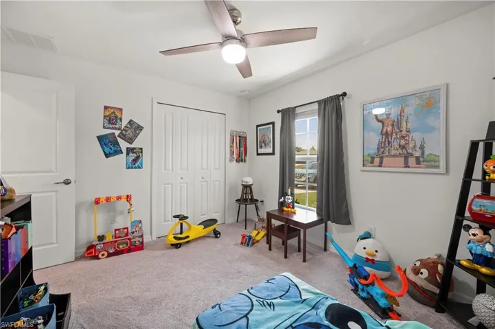 Game room with carpet flooring and a ceiling fan