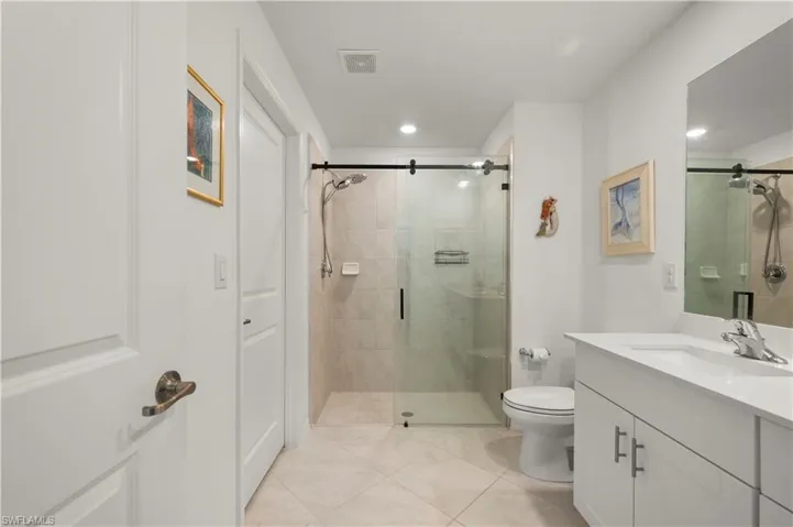 Full bath featuring vanity, tile patterned flooring, a stall shower, and recessed lighting