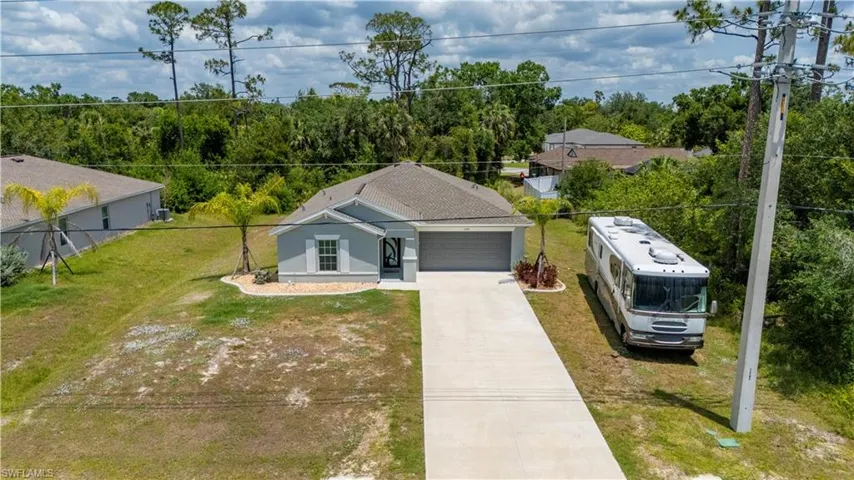 View of front of property with concrete driveway, an attached garage, and stucco siding